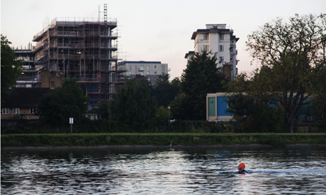 The Hackney Citizen's Josh Loeb swimming in the West Reservoir (with heron and Woodberry Down in background). Photograph: Eleonore de Bonneval