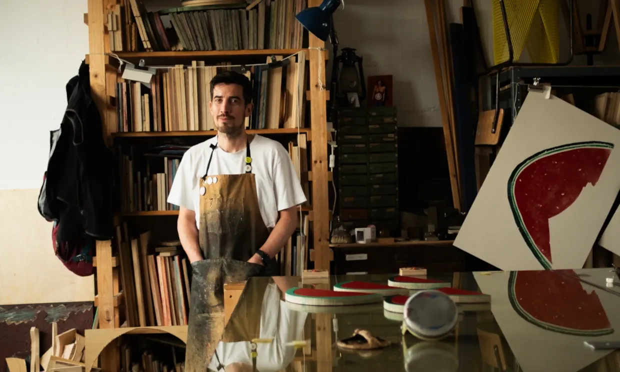 A man stands in his wood workshop