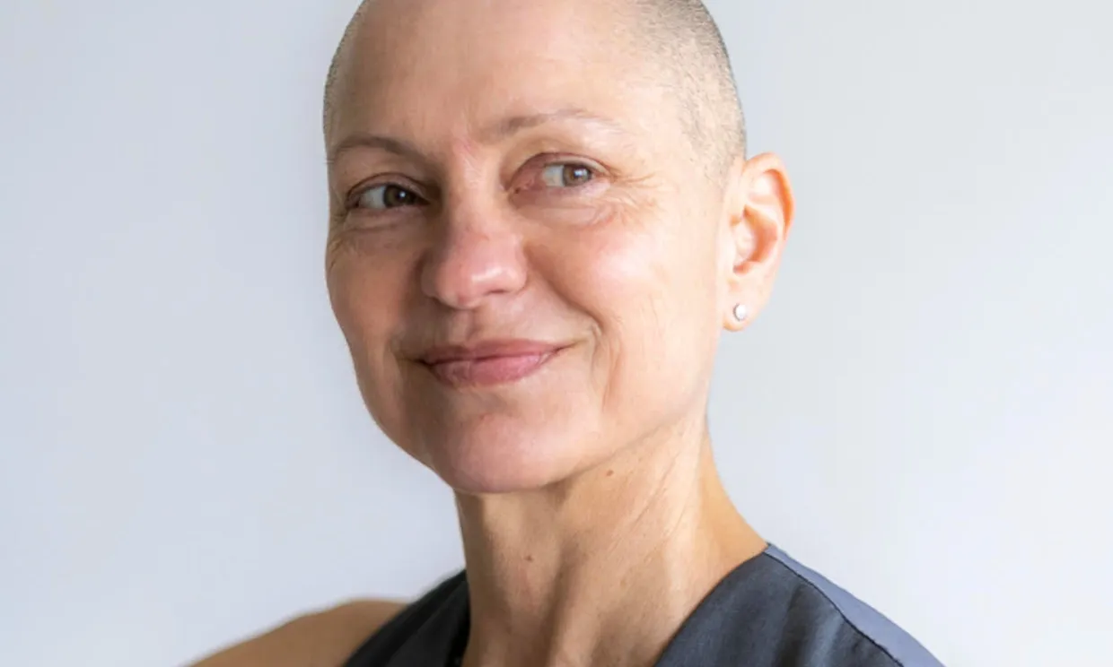 A close up shot of a woman smiling.