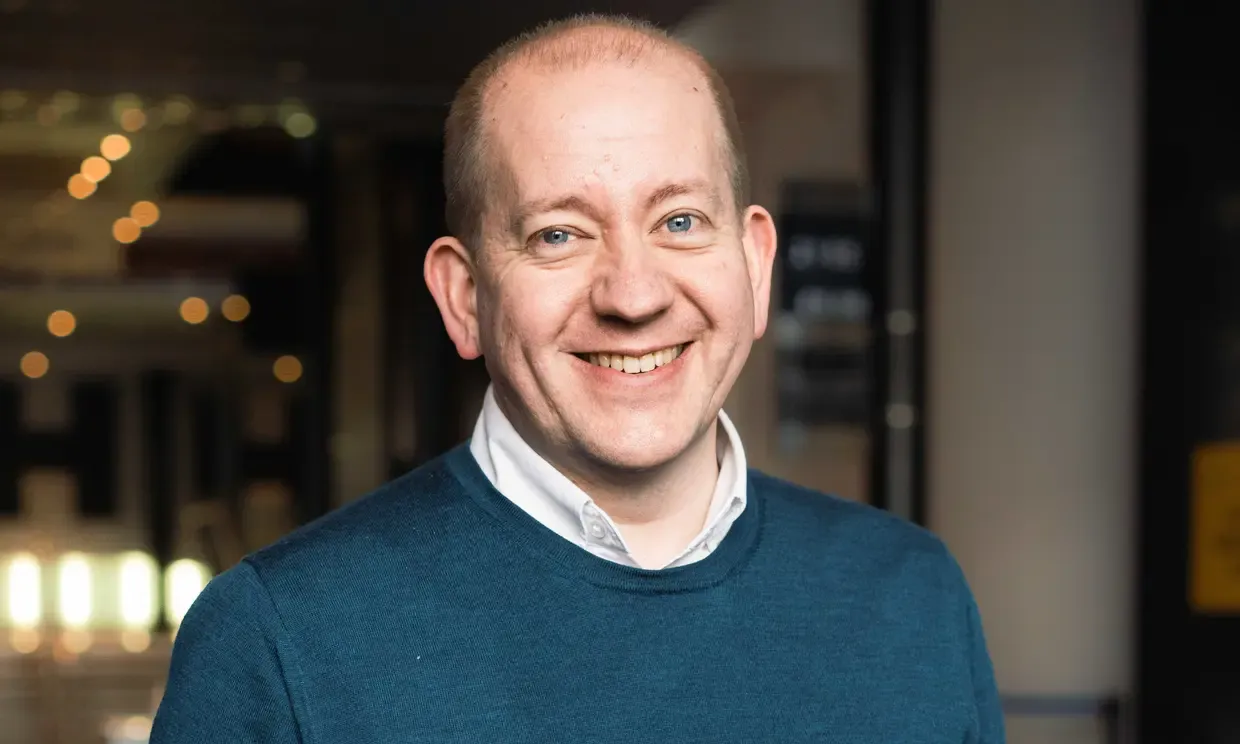 A man smiling to camera