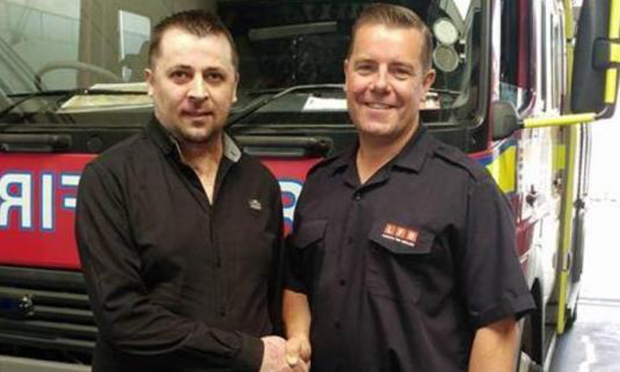 Constantin Huber (left) shakes hands with a fire fighter during a visit to Homerton Fire Station. Photgraph: London Fire Brigade