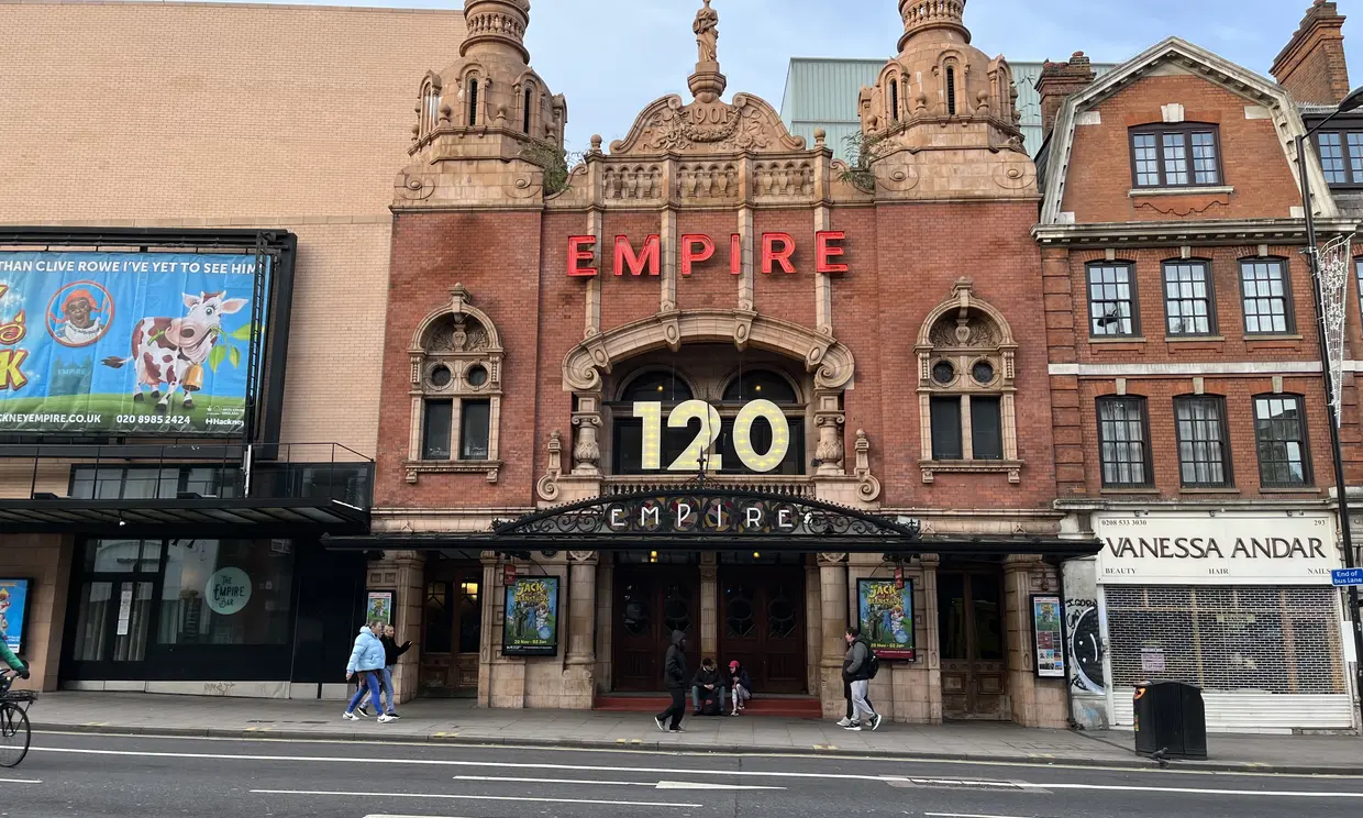 Exterior of Hackney Empire in the daylight. The sign reads "Empire: 120"