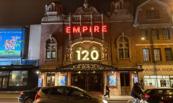 Exterior of Hackney Empire at night. 120 is in bright lights