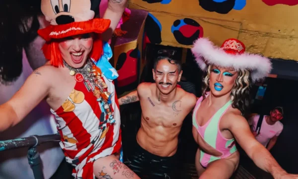 Drag performers stand in the stairwell of the club.