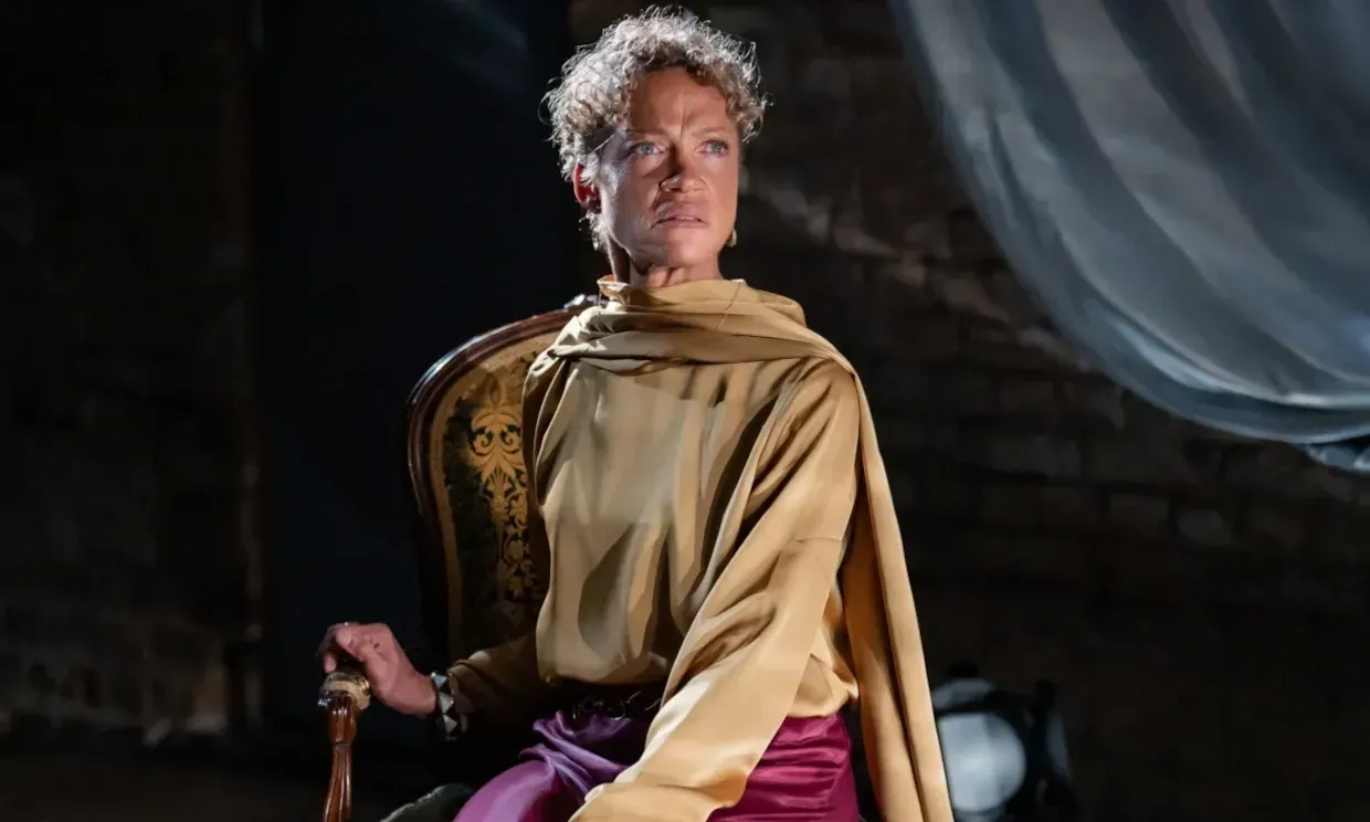 Indra sat in a chair looking angered.