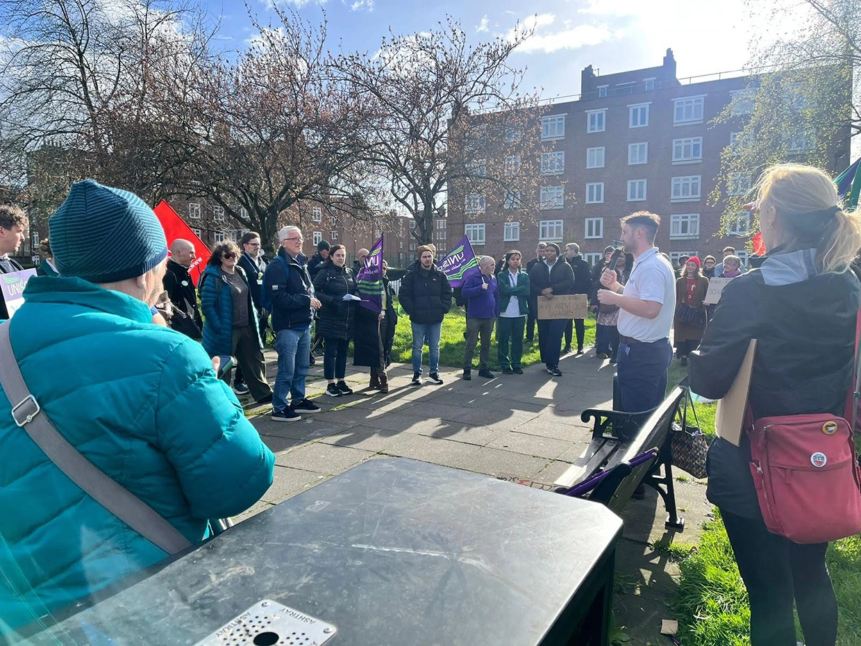 A speaker addresses the crowd of protestors.