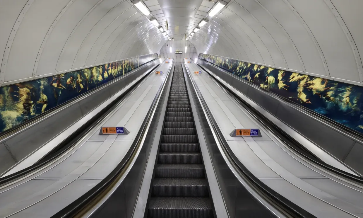A photo from the bottom of the tube station escalators - Phoebe's artwork is featured either side