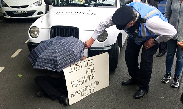 A young man begins the traffic blockade by sitting in front of a tax
