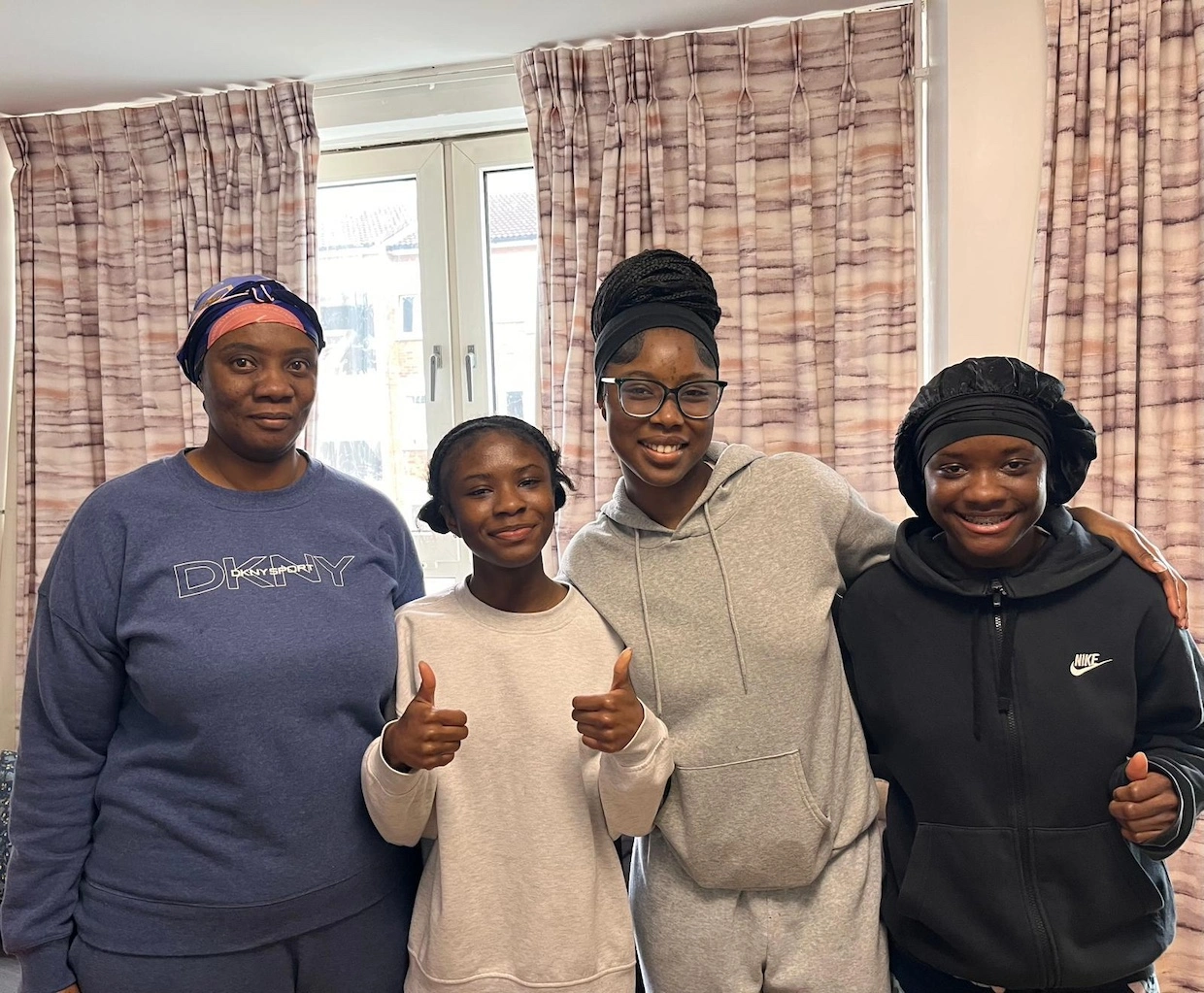 Charity Oppong (far-left) with her children Natalie Adu-Poku (centre-left), Nana Boateng (centre-right), and Alicia Adu-Poku (far-left)