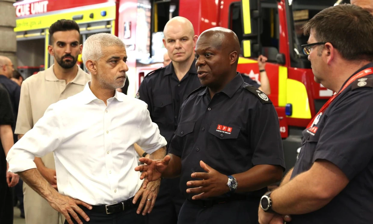 Sadiq Khan in deep conversation with a member of the fire service