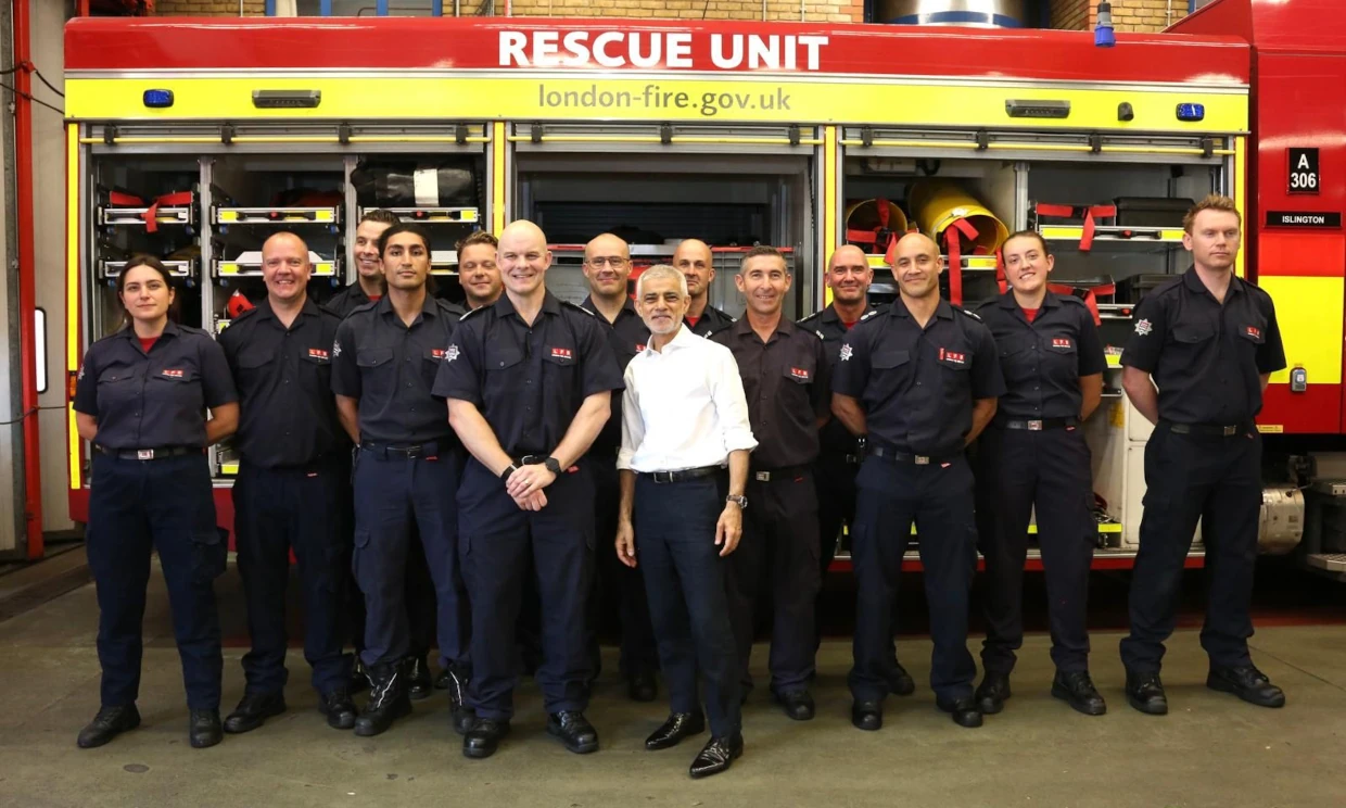 Sadiq Khan standing with members of the fire service