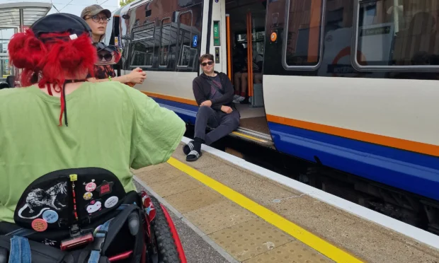 Zac sat in the train doors at Homerton Overground Station