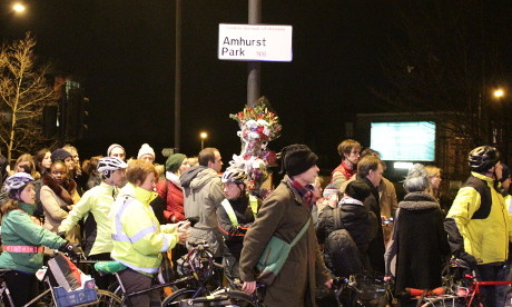 Cyclists gather at the crash spot on Amhurst Park