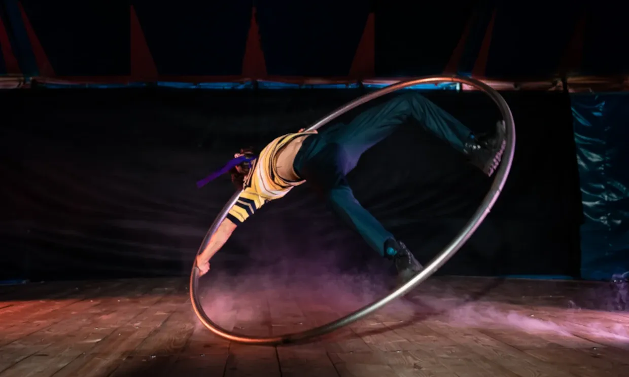 A performer spins inside a cyr wheel