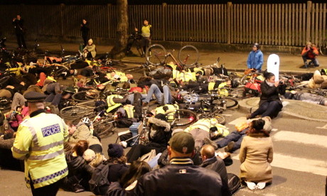 Demonstrators lie in the road for two minutes at vigil for cyclist Stephanie Turner. Photograph: Ella Jessel