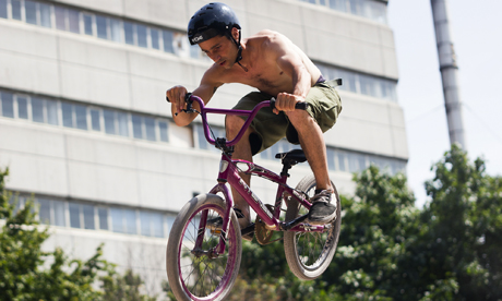An airborne biker prepares for landing at Haggerston BMX track