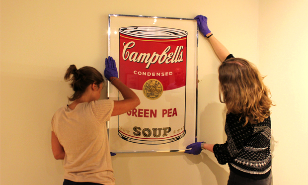 Soup of the day: Hackney Museum workers hang their Warhol. Photograph: Hackney Museum
