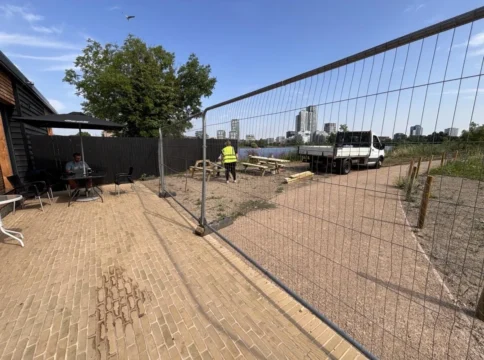 West Reservoir path opens — but row grows over fence that keeps non-swimmers from the water